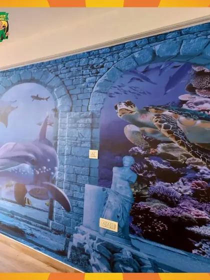 The stunning 3D underwater-themed wall mural, featuring dolphins and sea turtles. It creates an immersive experience and a fantastic backdrop for photos.