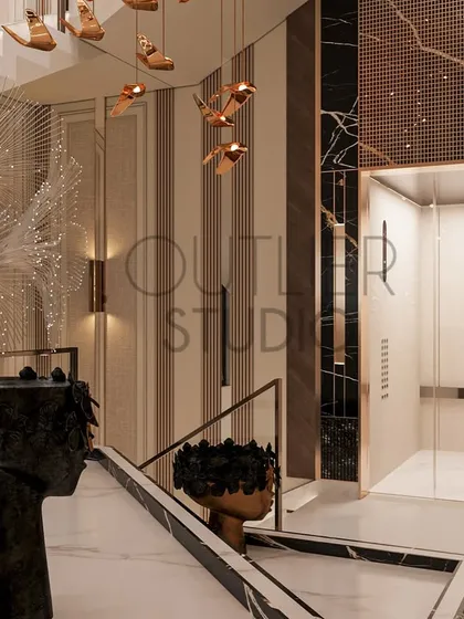 This view highlights the intricate details of the lobby, including a sculptural black marble basin, a feather-like art piece, and another cascading chandelier, all contributing to the grand experience.