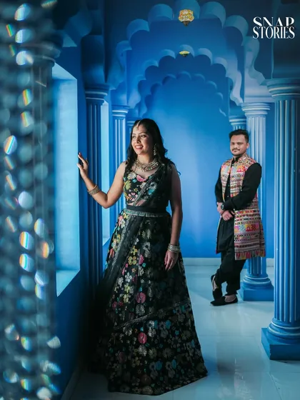 A creative portrait using a vibrant blue, Moroccan-style corridor. The unique architecture and bold color make for a striking and memorable pre-wedding photo.