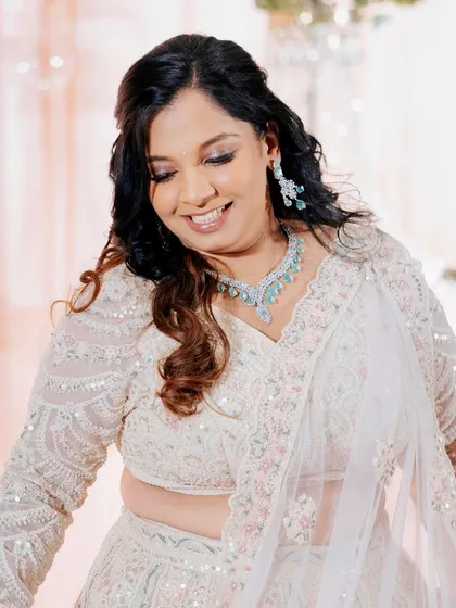 The third outfit for the engagement party, a beautiful white lehenga. We did a bold transformation in the eye makeup and hairstyle for this final look.