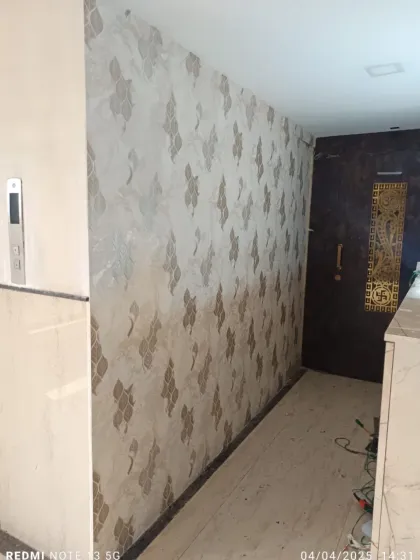 A beautiful damask-style wallpaper with a subtle texture, installed in a client's entryway. It creates a welcoming and elegant first impression.