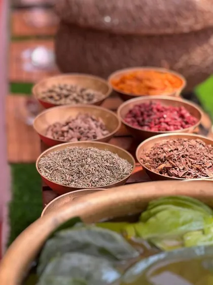 A traditional live paan station, with all the authentic ingredients laid out in brass bowls for a classic post-meal refreshment.
