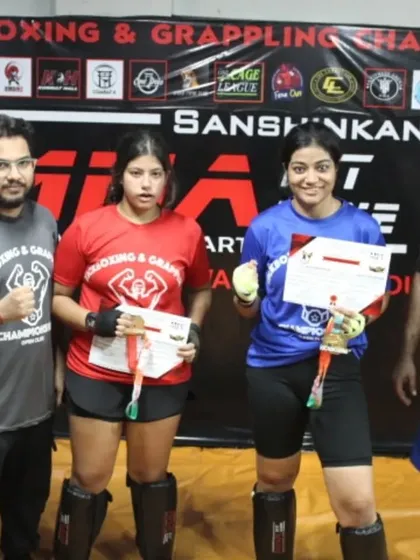 Two more champions from our club championship, proudly displaying their awards. These events foster a healthy competitive spirit within our gym community.