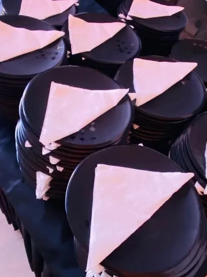 Simple, elegant, and practical. We use classic black plates with neatly folded white napkins for a modern and clean look that suits any corporate or private event.