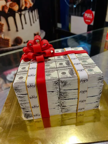 A side view of the money stack cake, showing the realistic texture of the stacked bills.