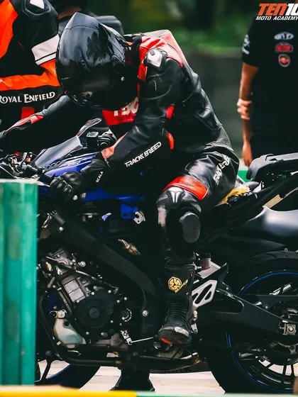 Adjusting your position on the bike is crucial for balance and control. This shot captures a rider making fine adjustments before entering a corner, a detail we focus on heavily in our coaching.