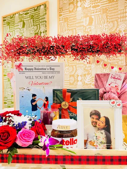 This is more than a gift, it's a grand romantic gesture. I designed this Valentine's hamper for him with a stunning arch of red gypsy flowers, a personalized 'love newspaper' sharing their story, and a curated selection of grooming essentials and gourmet treats.