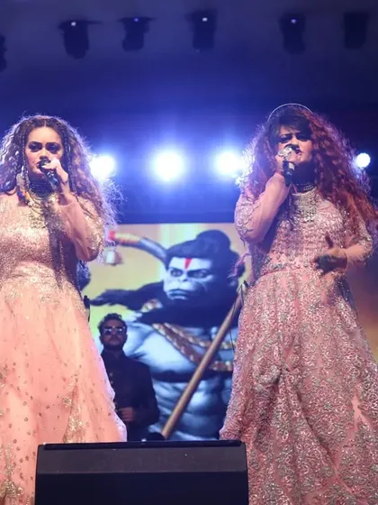 Singing a powerful song with a backdrop of Lord Hanuman, creating a divine and energetic atmosphere during our performance.