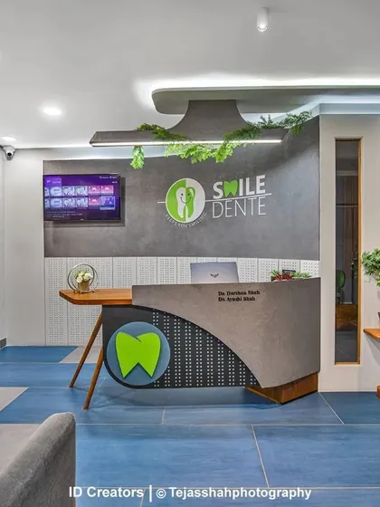 The reception desk is a custom-designed piece with a curved form and integrated branding, creating a professional and modern first impression.