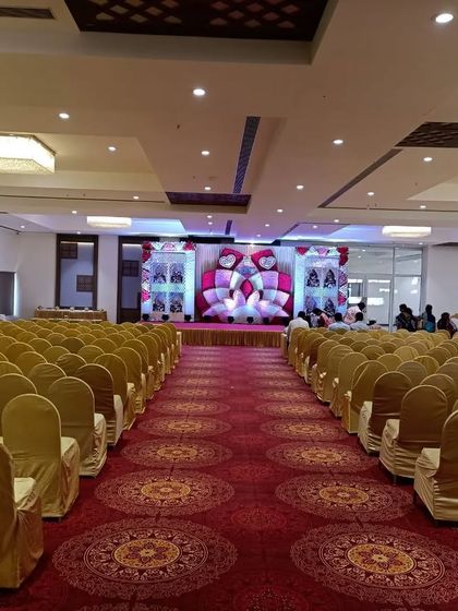 A view down the main aisle of Balaji banquet hall in Panvel. The hall is set up with theatre-style seating, perfect for wedding ceremonies and receptions.