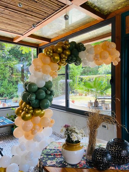This side angle shows the depth and structure of the organic balloon arch. I build these to fit perfectly within your space, whether it's framing a doorway or a corner table.