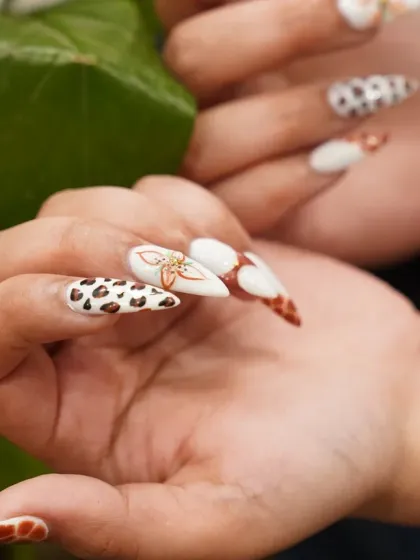 A closer look at our detailed 3D nail art. This set features a mix of animal print and floral designs on a sharp stiletto shape for a bold, fashion-forward statement.