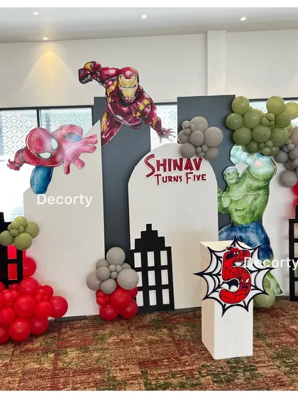 A closer view of the Avengers backdrop, highlighting the personalized "Shinav Turns Five" sign and the detailed character artwork.