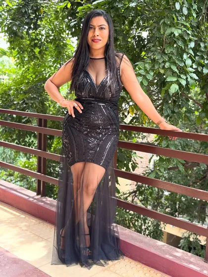 A full-length view of my sequined black gown, perfect for a glamorous awards night or gala dinner. My versatile style ensures I am always appropriately and elegantly dressed for your event.
