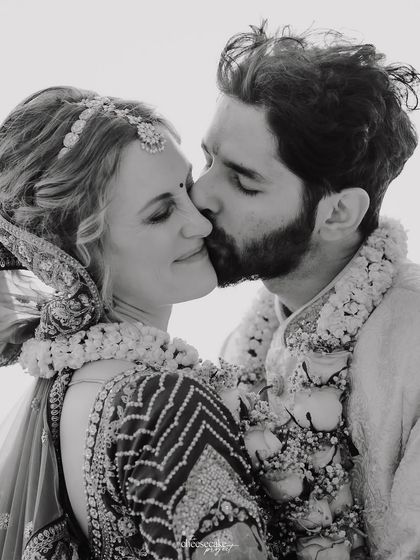 A sweet kiss on the cheek, captured in timeless black and white.