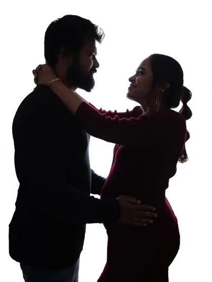 A classic couple's silhouette against a bright white background. This timeless style is perfect for capturing the connection between partners in a simple, artistic way.