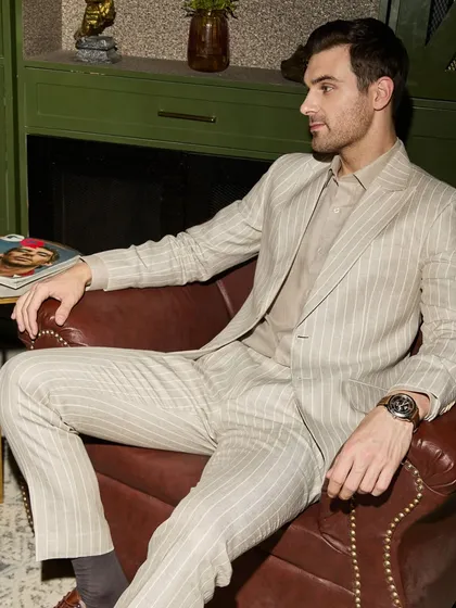 Power and style meet in this custom pinstripe suit, tailored from breathable Irish Linen. It's designed not just for the boardroom but for any setting where making a strong, elegant impression is key. The fit is relaxed yet structured.