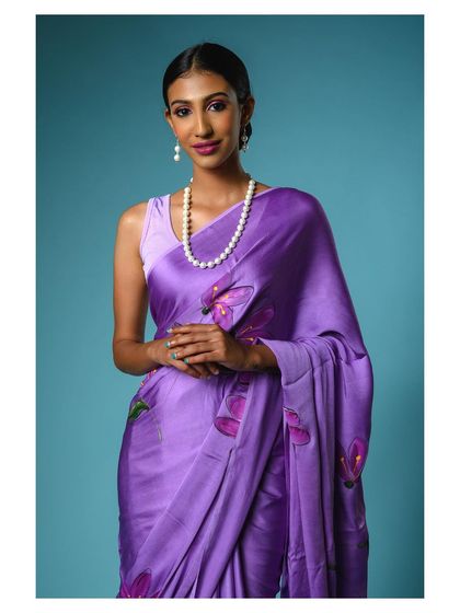 A direct, engaging shot of the model in the purple saree. This classic e-commerce style photo is clear, well-lit, and focuses entirely on the product and its presentation.