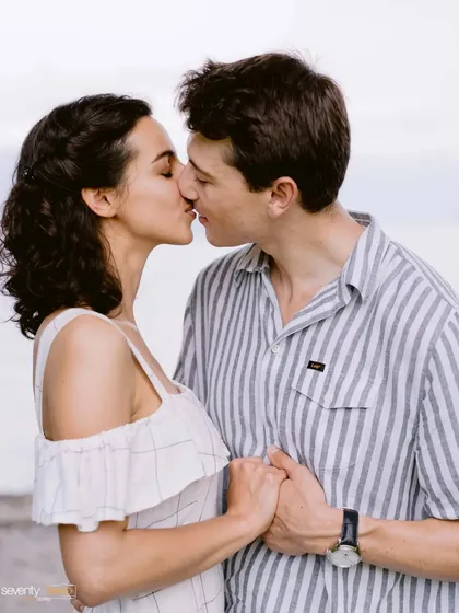 A sweet, gentle kiss by the water. This photo is all about the simple, profound intimacy of a shared moment, a quiet promise between two people.