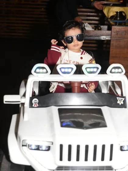 Capturing the cool attitude of a one-year-old birthday boy in his miniature toy jeep. These fun, personality-filled shots are a great way to remember the little details of your child's milestone party.