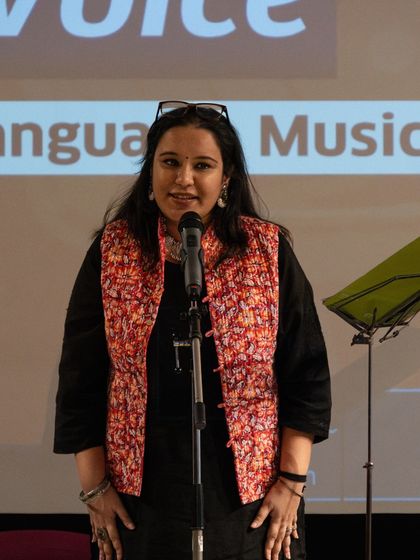 A participant sharing her work on stage. Our workshops bring together a diverse group of poets who learn and grow together.