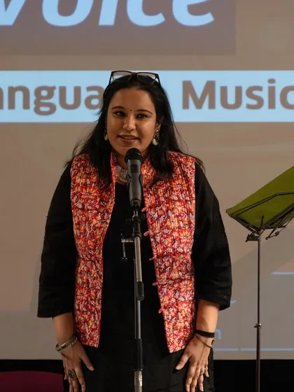 A participant sharing her work on stage. Our workshops bring together a diverse group of poets who learn and grow together.