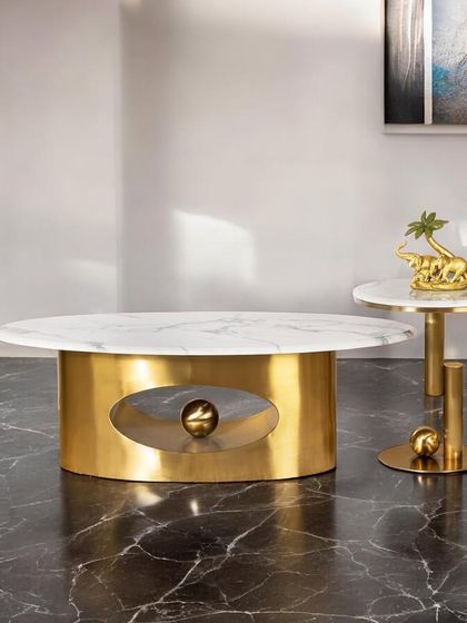 Here is another view of our standout coffee table with a central spherical accent. Paired with a matching side table, it creates a cohesive and luxurious look for your living room or entertainment space.