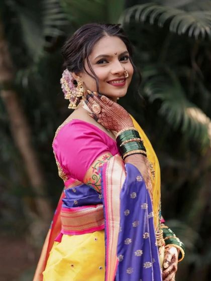 This side profile shows the delicate wisps of hair framing her face, adding a soft, romantic touch to the traditional updo.