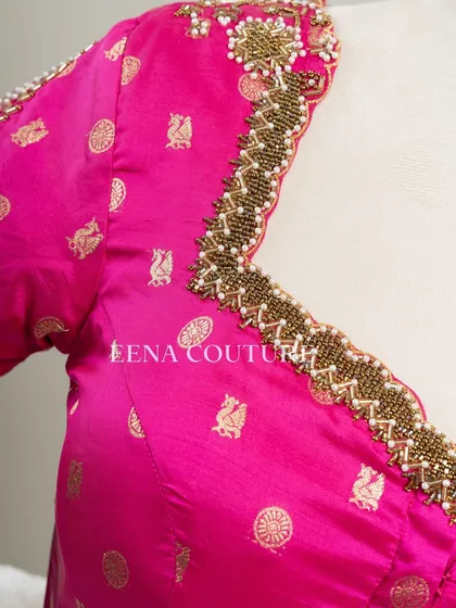 A closer look at the craftsmanship of this pink pure silk blouse. It features intricate handwork with bead detailing on the neckline and delicate net sleeves with linear embroidery for a touch of grace.