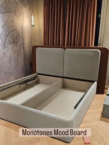My hydraulic beds are a game-changer for storage. This design features a dual-tone upholstered headboard and a powerful lift-up mechanism, revealing a huge amount of organized space for your linens and extra items.