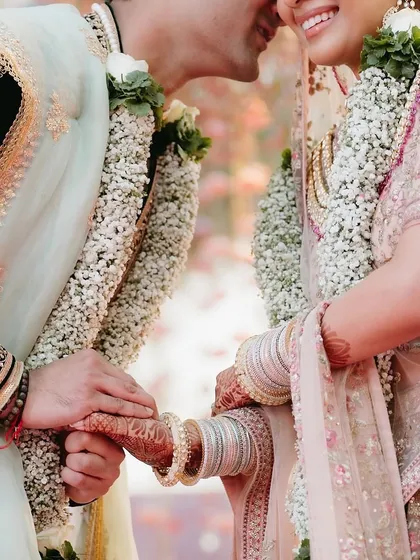 An intimate close-up of the couple during their varmala ceremony. Beyond the grand decor, we focus on creating the moments of connection and emotion that are the true heart of any wedding.