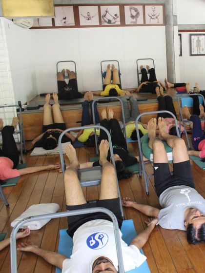 A class using chairs for a supported inversion. This is a wonderful way to experience the restorative benefits of inversions without any strain.