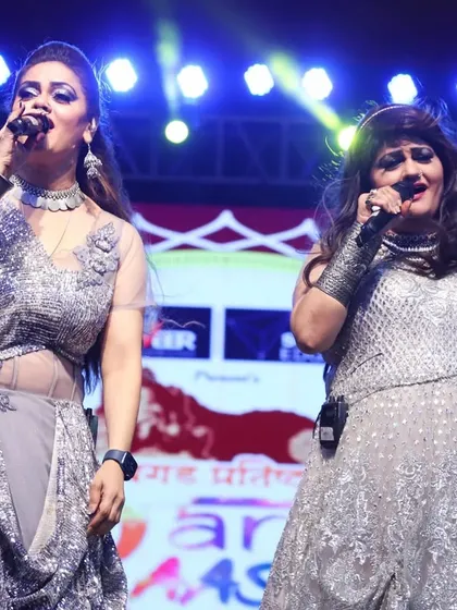 Singing side-by-side in sparkling silver gowns. Our coordinated outfits are a key part of our stage identity.