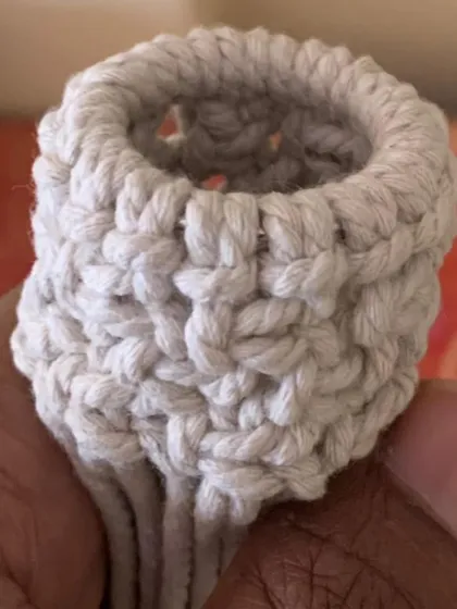 A close-up of a student's mini plant pod, showing the great texture they achieved with the knots.