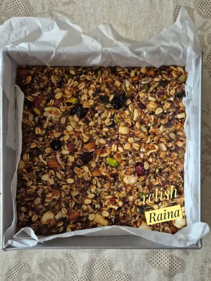 This is a full tray of my granola mixture before it's cut into bars. It's a wholesome blend of rolled oats, nuts, seeds, and dried fruits, ready to be baked.