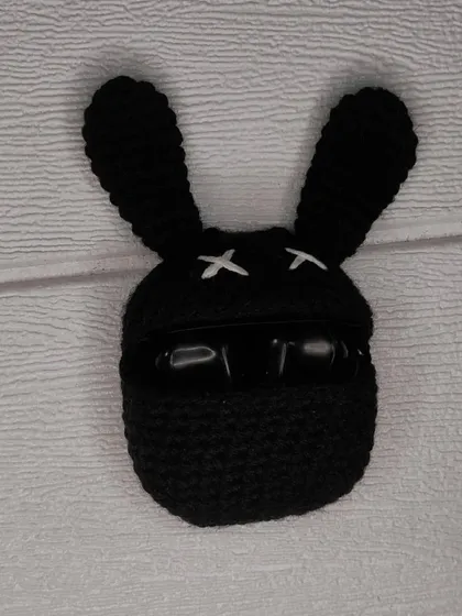 The bunny AirPods case in action, keeping your earbuds safe and sound inside its crocheted belly.