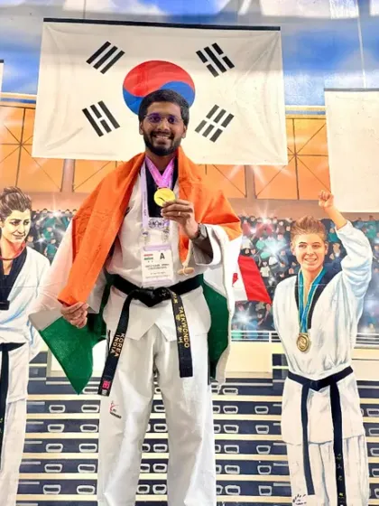 A proud moment with my medal and the Indian flag at the World Taekwondo event.