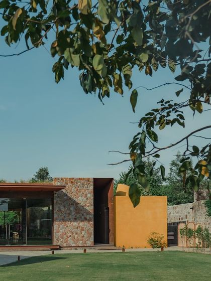 Here you can see how we've integrated natural stone walls with glass and our signature ochre finish, blurring the line between indoor and outdoor spaces.