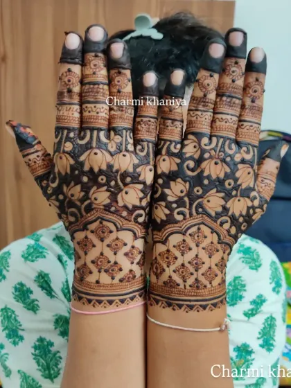 A fancy lotus design that fills the entire hand. The use of negative space around the flowers makes the pattern pop, creating a bold and beautiful statement.