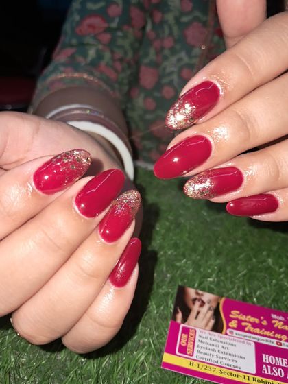 A classic red nail set with a beautiful gold glitter ombre on the accent nails.