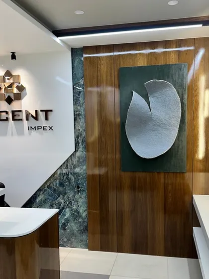 'Edge of Perfection,' a bespoke artwork curated for the Decent Impex office in Bhavnagar. The clean, minimalist form made from upcycled paper reflects the company's focus on precision and innovation.