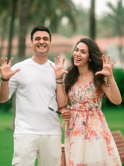 A fun and energetic shot of the couple showing off their rings (or just being playful), perfect for a Save the Date announcement.