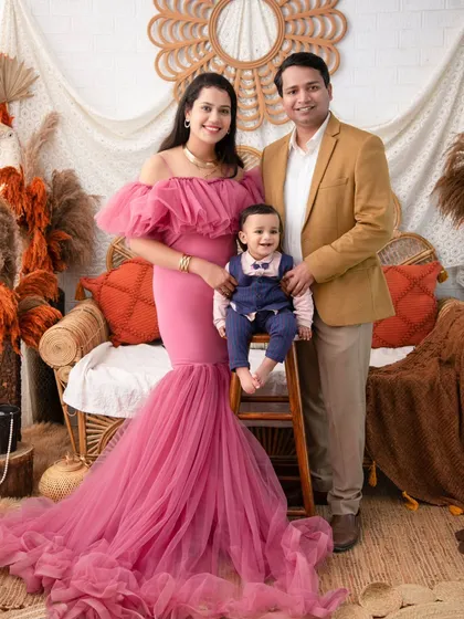 A complete family portrait in our autumn boho setup. The family's coordinated outfits look perfect against the rich, warm colors of the theme.