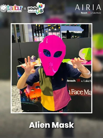 Kids making their own alien masks to wear at the Alien World event.