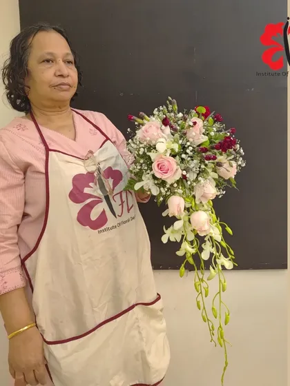 Another wonderful example of a cascading bouquet from our class. This student has skillfully combined roses and orchids to create a design with beautiful movement and shape.