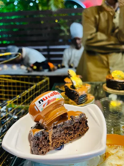 A sweet ending makes any event memorable. This decadent chocolate cake topped with a mini Nutella jar is a crowd favorite, showcasing my commitment to creating fun and indulgent desserts.