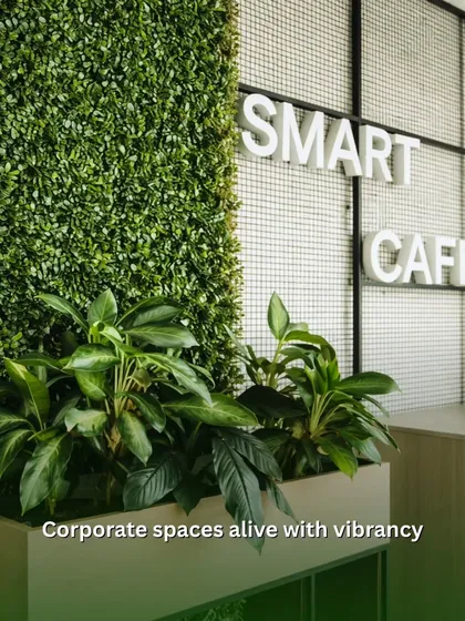 Making corporate spaces come alive with vibrancy. At this Smart Cafe, we installed a combination of a dense green wall and potted peace lilies to create a refreshing and welcoming atmosphere for employees.