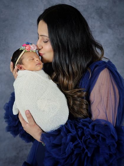 A tender moment between mother and baby. A gentle kiss on the forehead is a simple but incredibly powerful expression of love that I always hope to capture.
