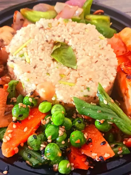 A wholesome and colourful millet bowl, artfully arranged with sautéed mushrooms, crisp vegetables, and pan-fried tofu. This is a perfect template for a quick, healthy, and complete meal.