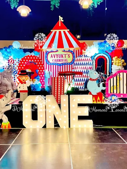 Step right up to a world of fun with my vibrant carnival-themed parties. This first birthday stage features a classic red and white striped circus tent backdrop, marquee letters, and playful animal character cutouts, ready for the main event.
